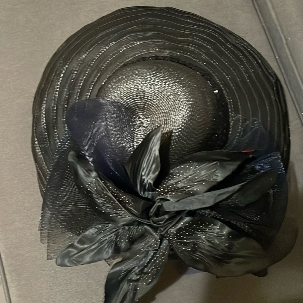Black hat with flowers and trim. Excellent condition 61/2 “ brim.